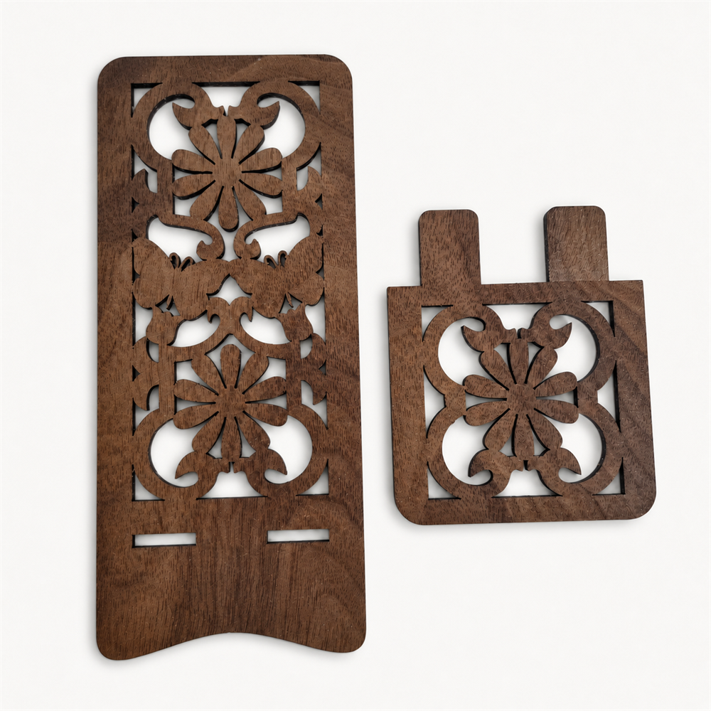 Two dark brown wooden decorative pieces with intricate laser-cut floral, butterfly and scroll patterns, displayed on a clean off-white background.