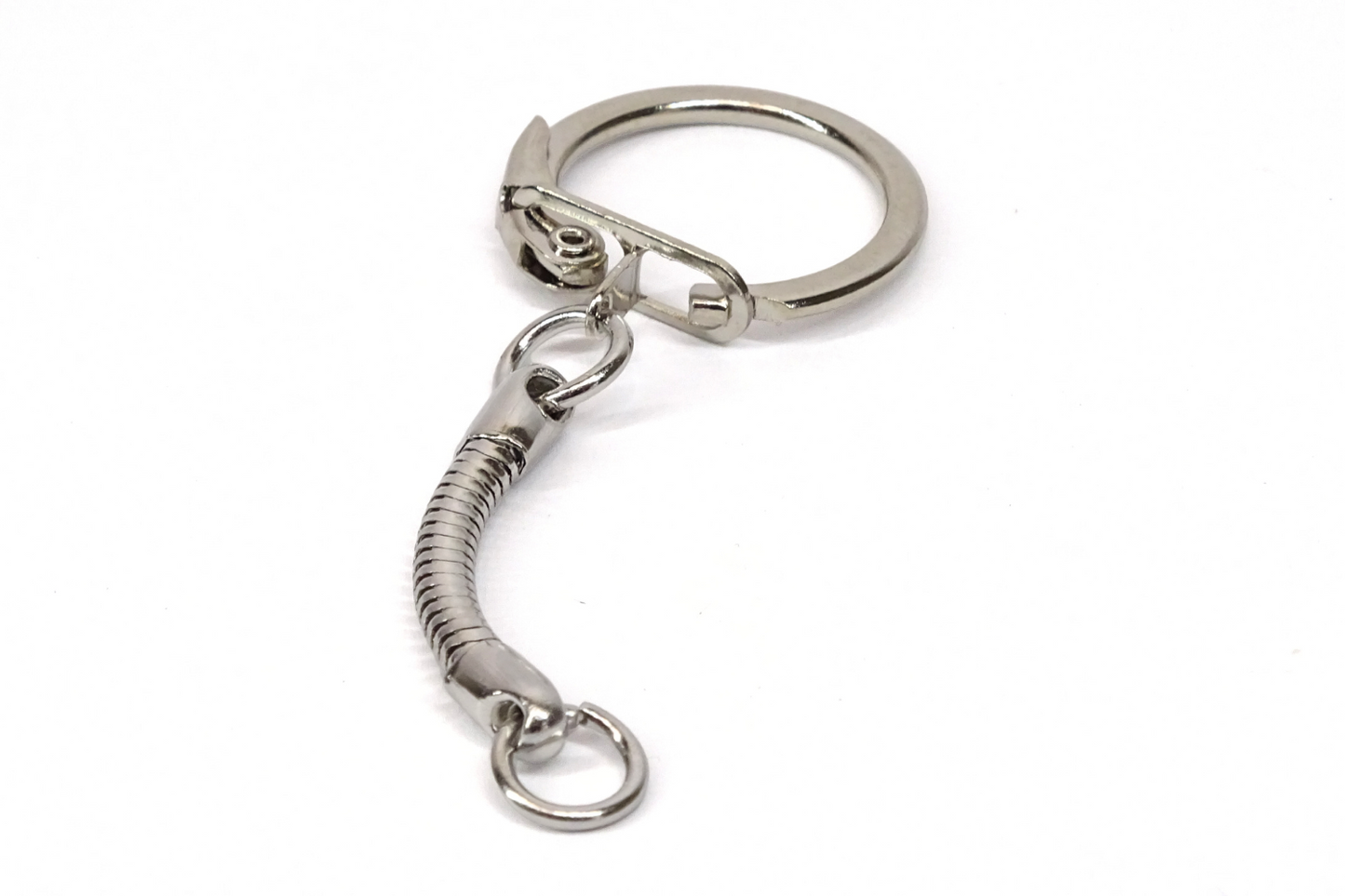 A single nickel plated key ring on a plain white background