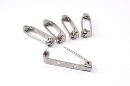 Pack of 5 brooch pins on a white back ground