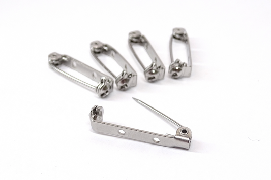 Pack of 5 brooch pins on a white back ground