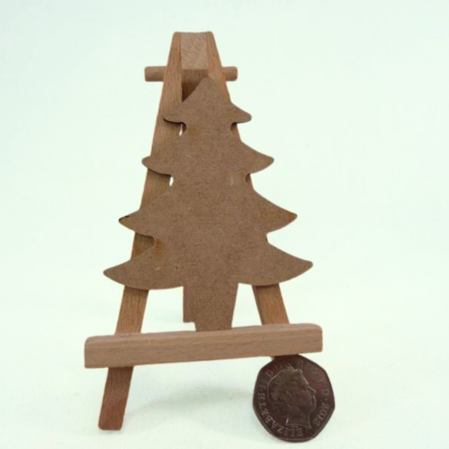 2mm mdf tree shape on a miniature easel. fifty pence piece beside it to show size  
