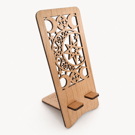 A light natural wood phone stand with intricate laser-cut geometric and star patterns, shown on a clean off-white background.