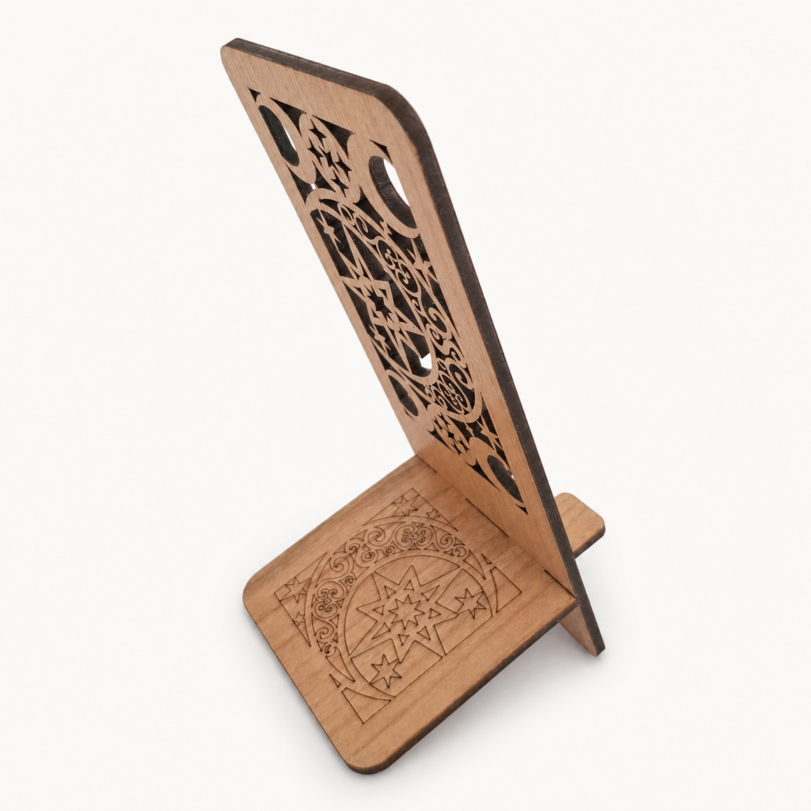 A wooden stand with intricate laser-cut patterns on the back panel and engraved geometric designs on the base, shown on a clean off-white background.