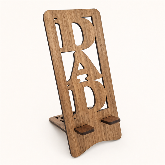 A wooden phone stand with the word 'DAD' cutout lettering, shown on a plain light background.