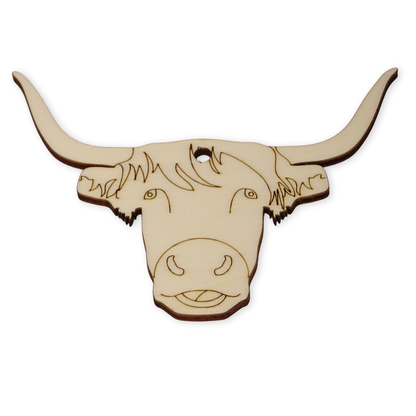 A highland cow shaped wooden craft shape on a white background. Showing the hole position and the laser etched face details on the surface of the wood.