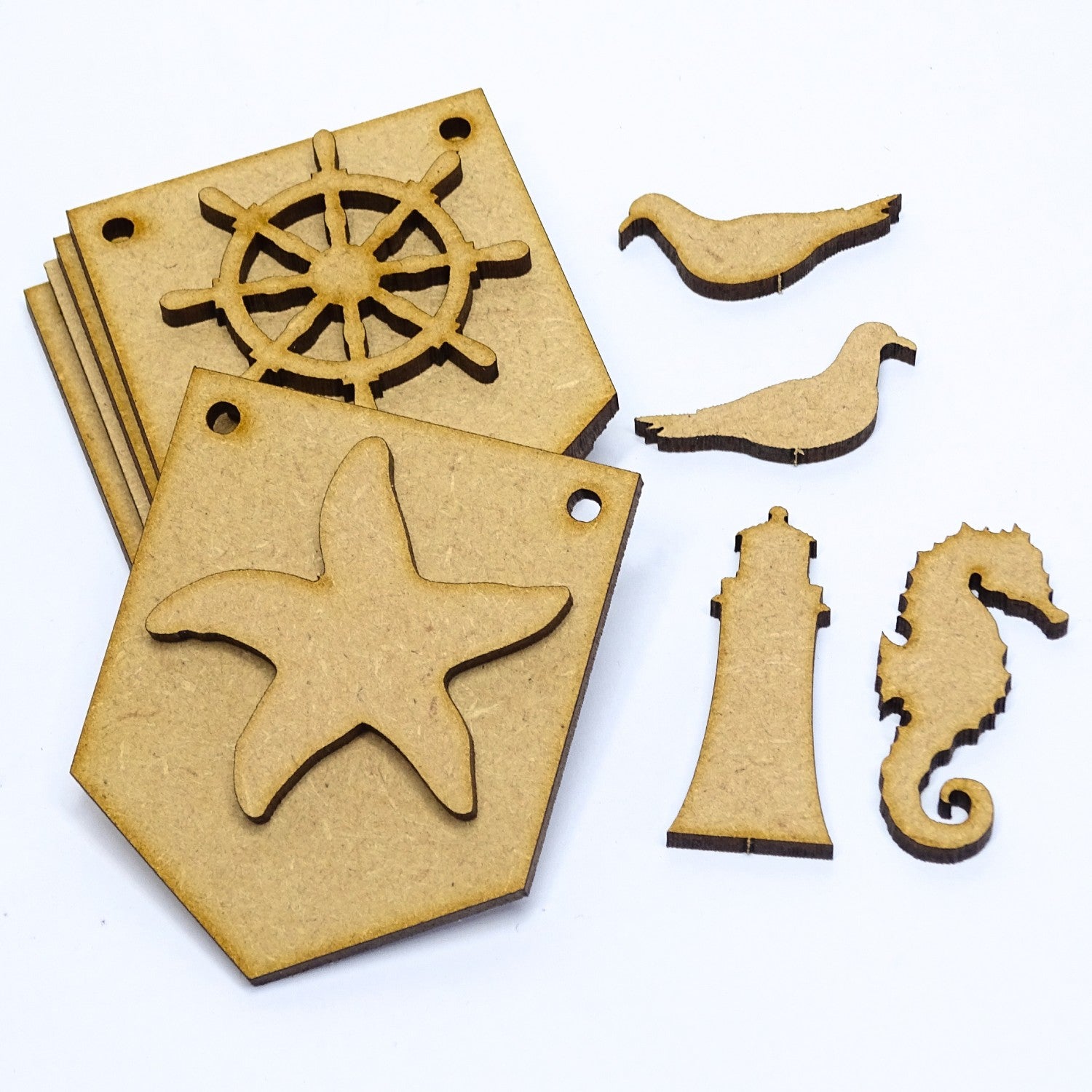Wooden nautical-themed cutouts including a starfish, ship wheel, lighthouse, and seahorse on a white background.