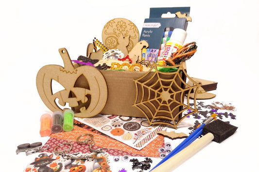 White background with a box full of Halloween themed craft items. 