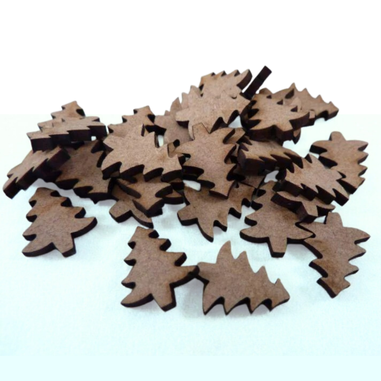 Mini Christmas tree cut-outs on a light green background