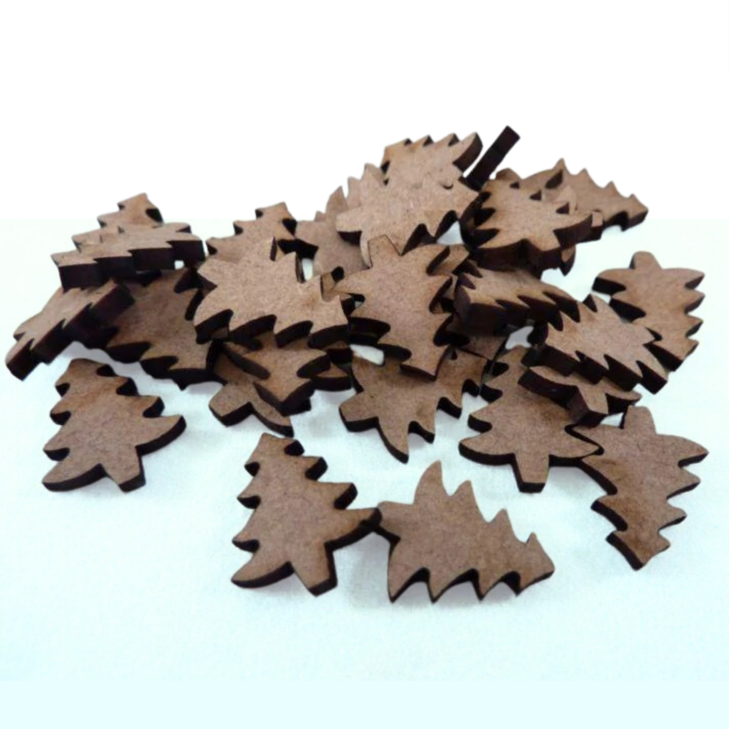 Mini Christmas tree cut-outs on a light green background