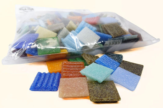 Clear bag of coloured glass tiles 20mm by 20mm with a small amount out of the bag showing bright colours