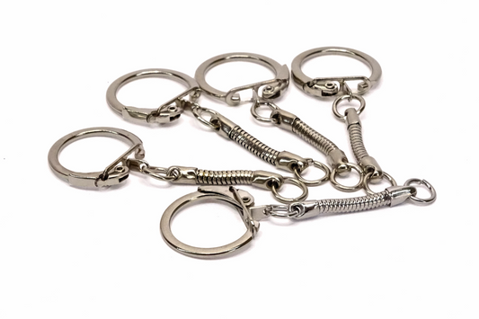 5 shiny nickel plated Keyrings on a plain white background