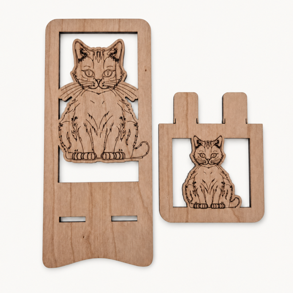 Two wooden parts of the phone stand with laser-engraved cat designs, displayed on a clean off-white background.
