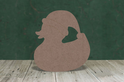 2mm MDF craft blank in the shape of a duck wearing a Santa hat on a wooden table and a green background.