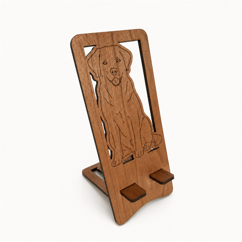A wooden phone stand with a laser-engraved dog silhouette, shown on a clean white background.